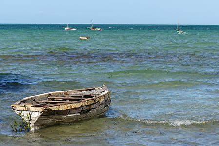 wrecked boat on shore during daytime thumbnail