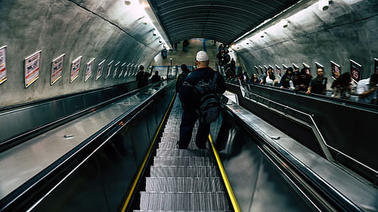 Man in Black Leather Jacket on Escalator thumbnail