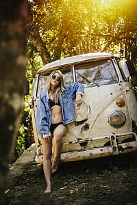 woman standing beside white car thumbnail