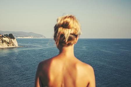 woman with brown hair in front of lake thumbnail