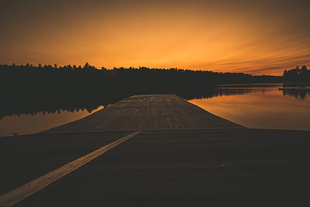 brown wooden dock during night time thumbnail