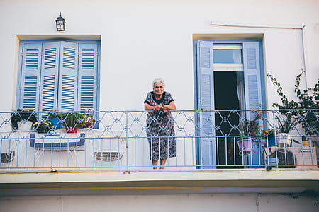 woman in dress standing on terrace during daytime thumbnail