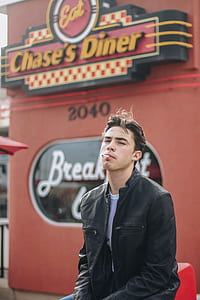man wearing black leather jacket near Chase's Diner cafe thumbnail