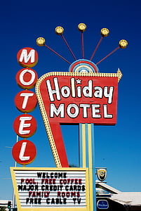 Holiday Motel neon sign under calm sky thumbnail