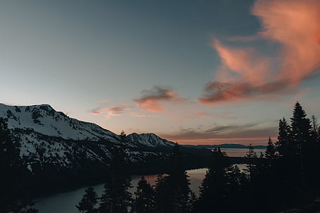 panoramic photo of glacier mountain under lake across trees thumbnail