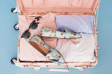 flat lay photo of luggage with garments thumbnail