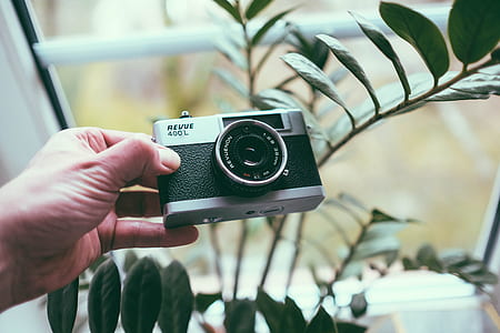 person holding black and silver camera thumbnail