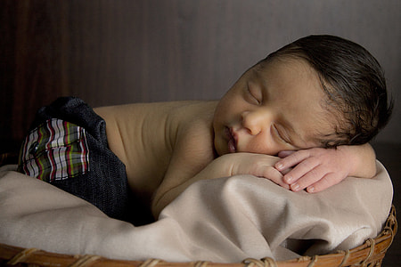 baby sleeping on top of brown leather textile thumbnail