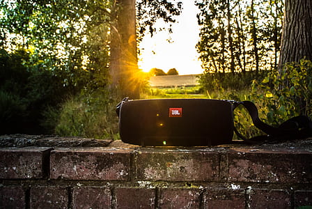 black JBL Xtreme Bluetooth speaker on brick wall thumbnail