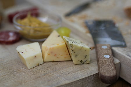 shallow focus photography of cheeses on chopping board thumbnail