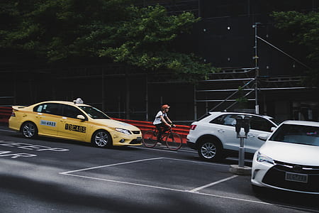 person riding bicycle between vehicles thumbnail