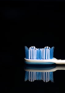 macro photography of white and blue toothbrush thumbnail