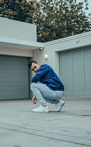 man sitting on floor near garage thumbnail