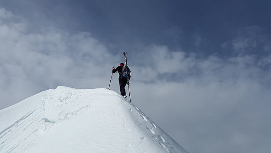 man climbing on top of snow mountain thumbnail