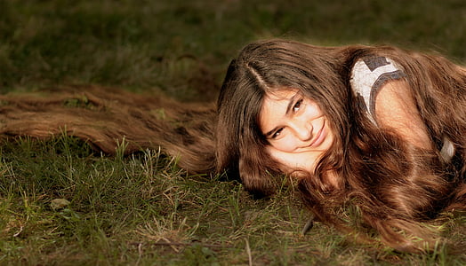 woman lying on green grass thumbnail