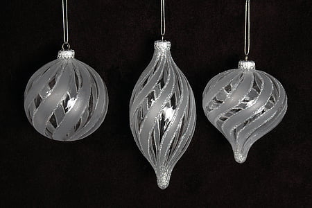 three gray baubles on dark background thumbnail