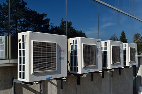 four white air condensers outside building thumbnail