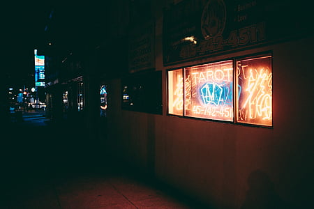 lighted signage beside sidewalk thumbnail