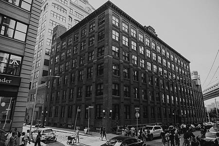grayscale photo of crowd near building thumbnail