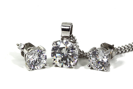 three silver-colored accessories with white crystals thumbnail