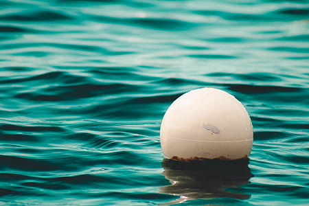 white ball in green body of water thumbnail