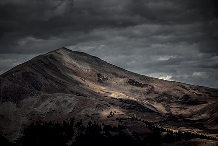 brown mountain under gray clouds thumbnail