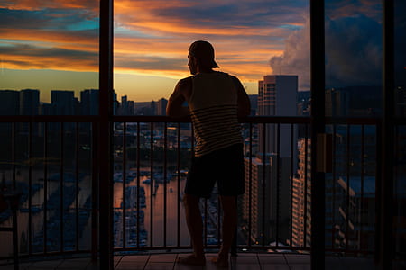 man leaning on balcony thumbnail