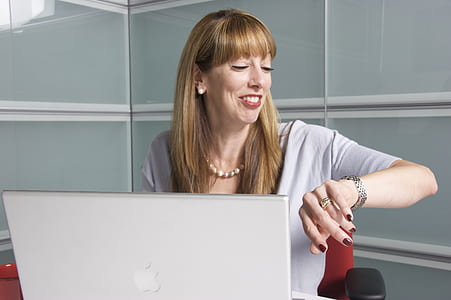 woman sitting on chair using silver MacBook thumbnail
