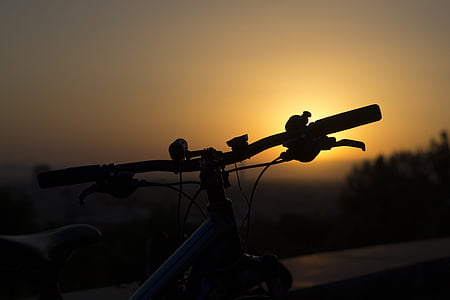 silhouette of bicycle during golden hour thumbnail