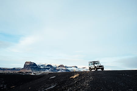 white Jeep Wrangler travelling along snowy road during daytime thumbnail