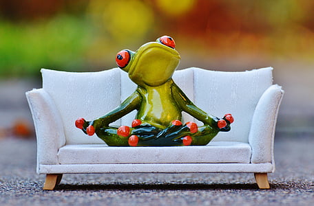 green and red ceramic frog figurine on white sofa thumbnail