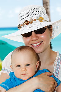 woman carrying baby on selective focus photo thumbnail