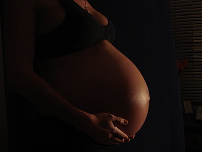 pregnant woman wearing black brassiere thumbnail