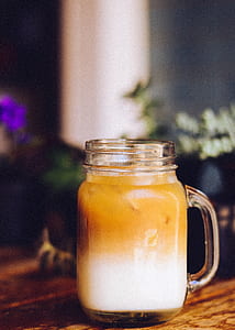 close up photography of clear glass mug filled with yellow liquid thumbnail