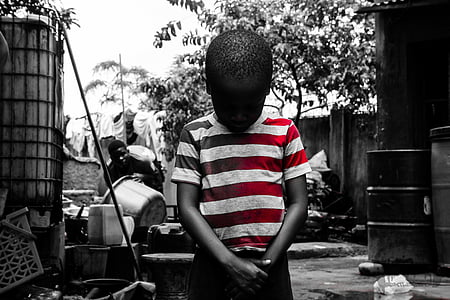 selective color photography of boy wearing stripe shirt looking down thumbnail