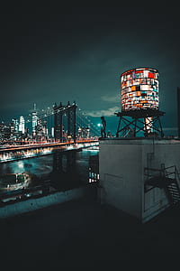 silhouette of person standing in rooftop near bridge thumbnail