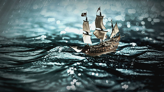 brown galleon ship on body of water during heavy rain thumbnail