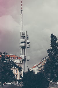gray steel tower near white concrete building at daytime thumbnail