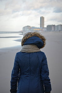 person wearing parka jacket near building thumbnail