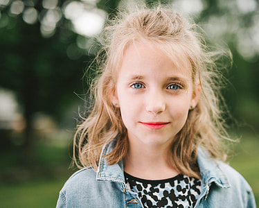 selective focus photography of girl wearing blue denim collared jacket thumbnail