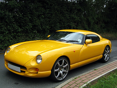 yellow sports car parked beside plants thumbnail