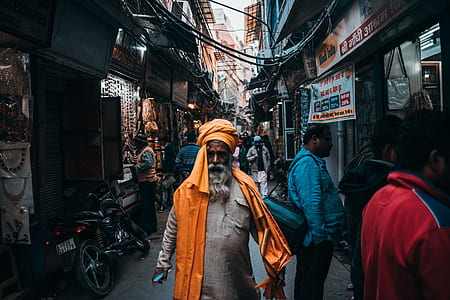 man walking in the street wearing orange turban thumbnail