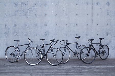 four bike parked near wall thumbnail