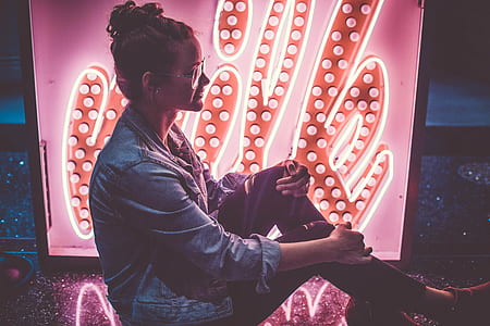woman sitting while holding her knees thumbnail