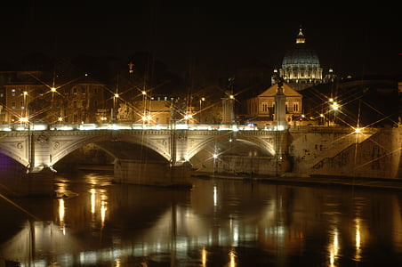 brown concrete buildings near water during night time thumbnail