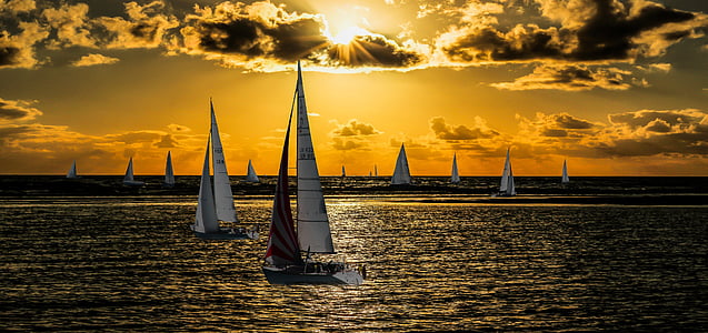 sailboats sailing on sea during sunset thumbnail