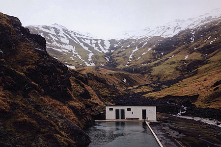 A building sits in the dramatic mountain landscape in Iceland thumbnail