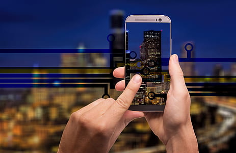 person taking photo of high rise building thumbnail