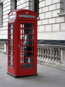 telephone booth beside brown building thumbnail