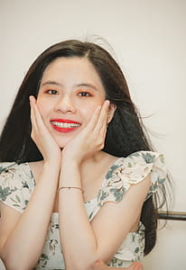 Smiling Woman Wearing White and Green Floral Dress thumbnail